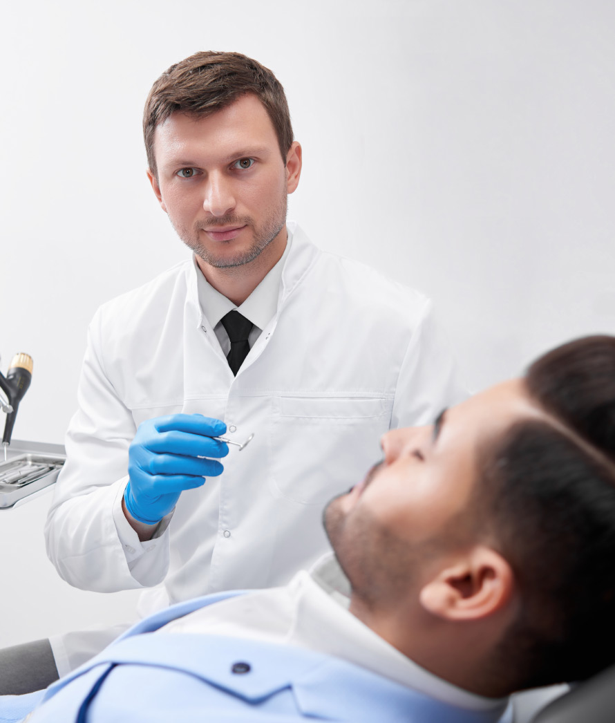 young-man-visiting-dentist-BEUGEF6.jpg